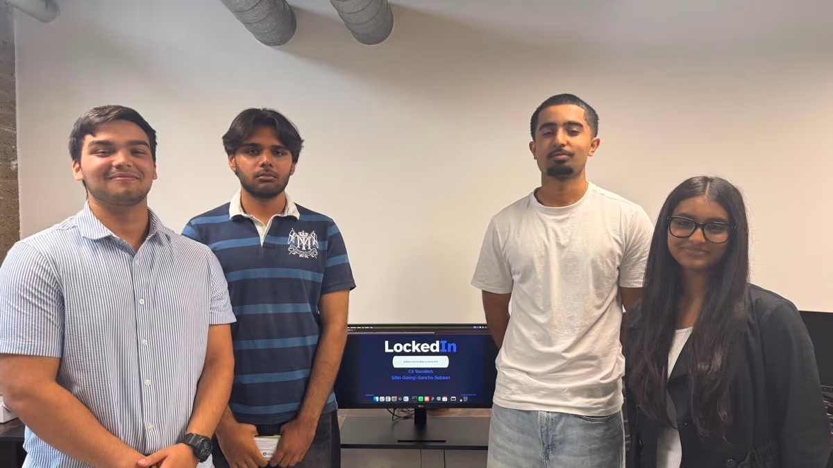 A team of sixth formers beside the startup they built, in the office.